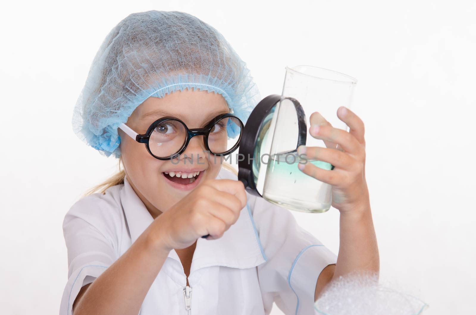 Girl sitting in chemistry class and makes the simplest experiments