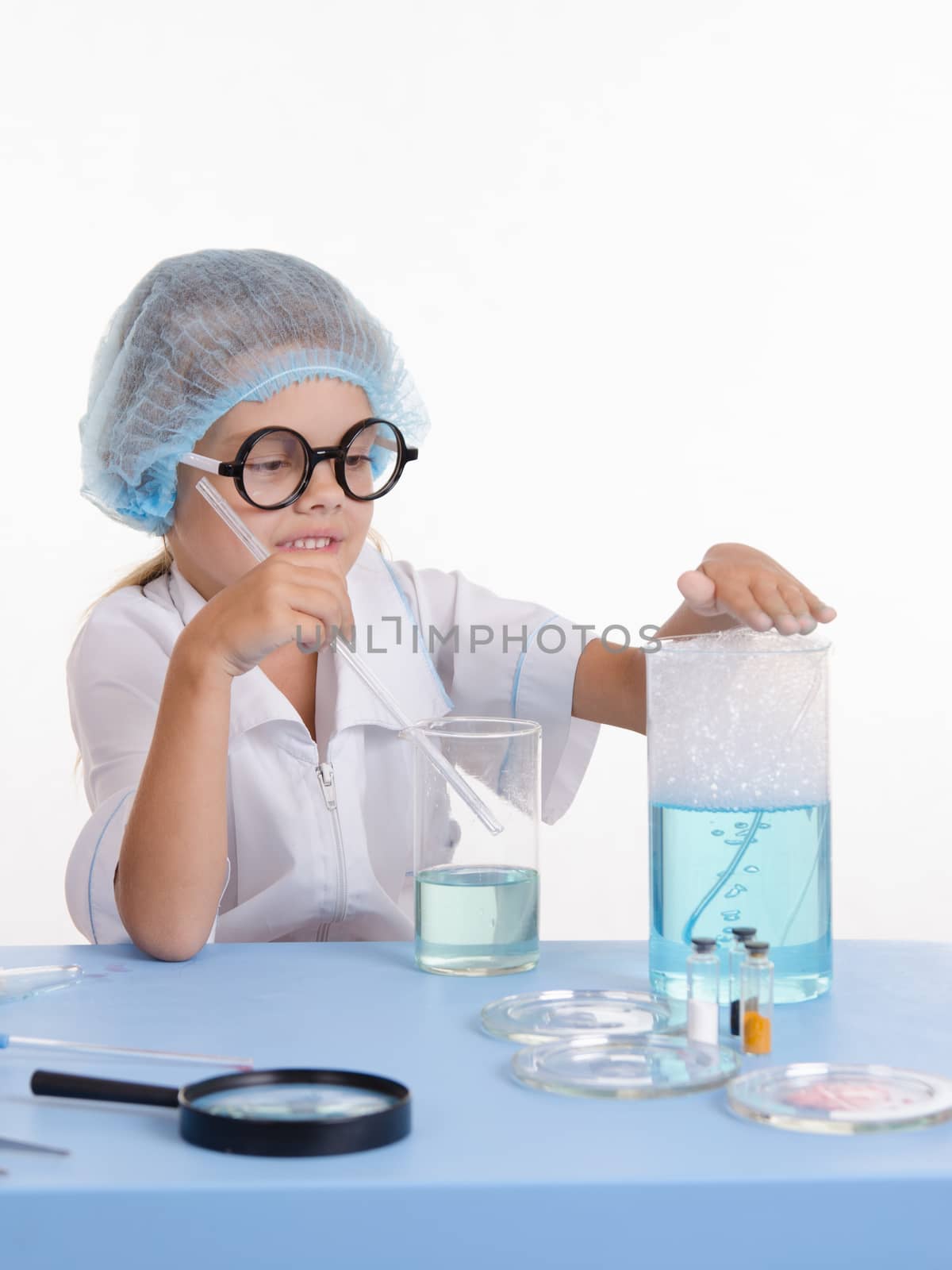 Girl sitting in chemistry class and makes the simplest experiments