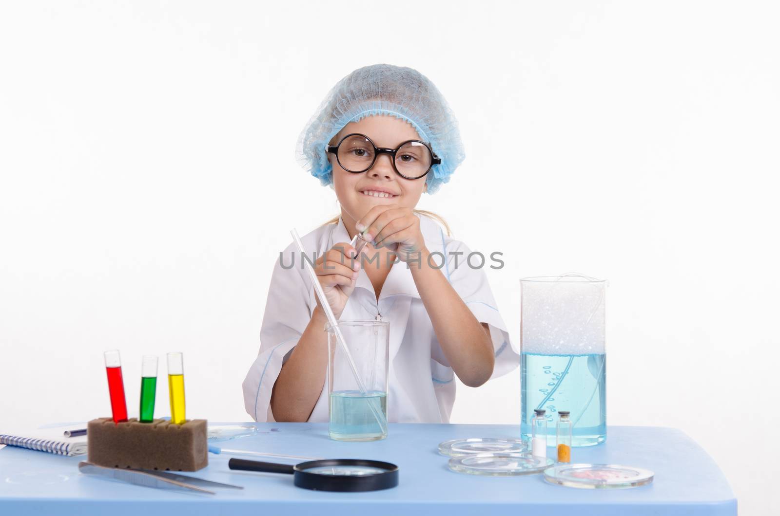 Girl sitting in chemistry class and makes the simplest experiments