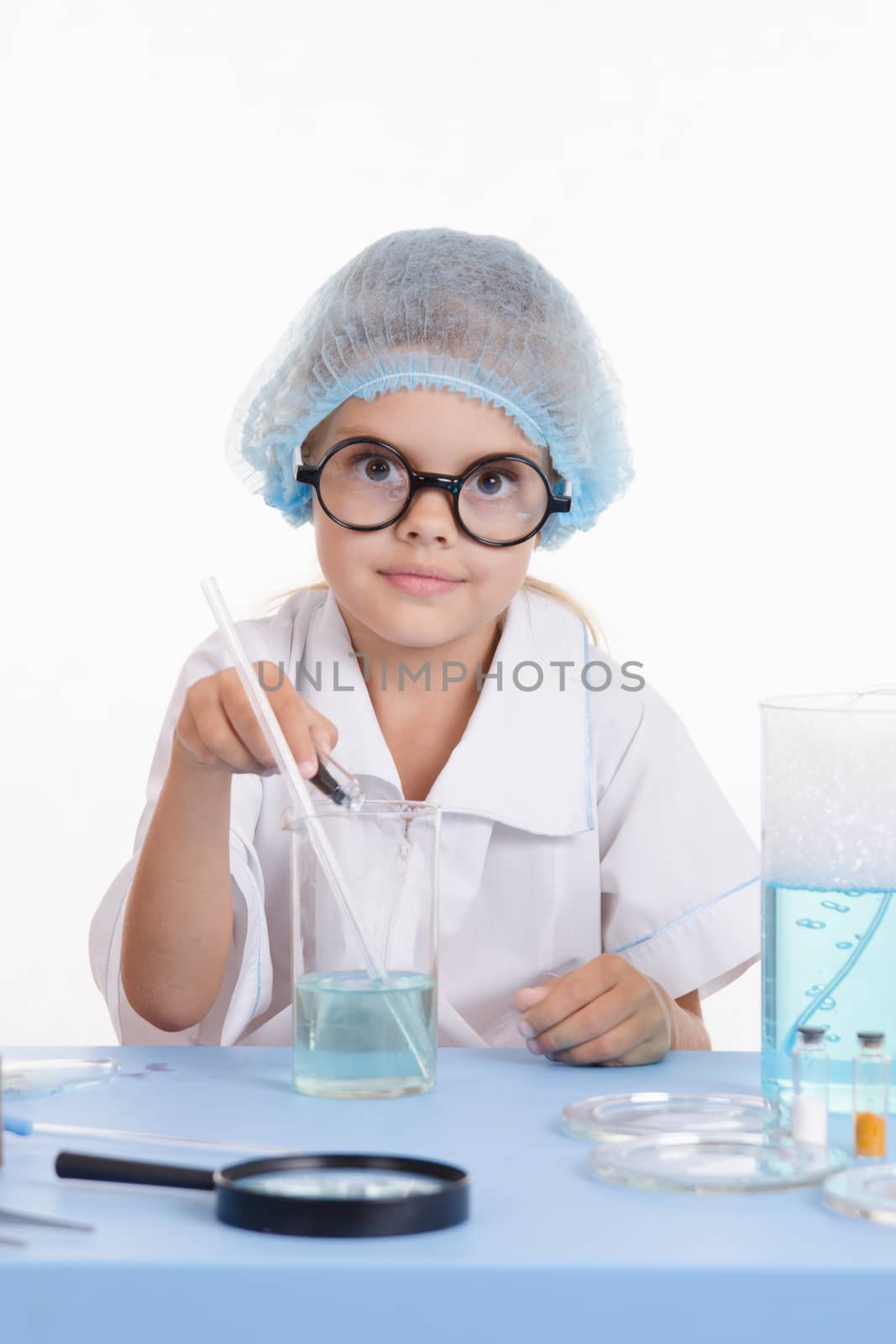Girl sitting in chemistry class and makes the simplest experiments