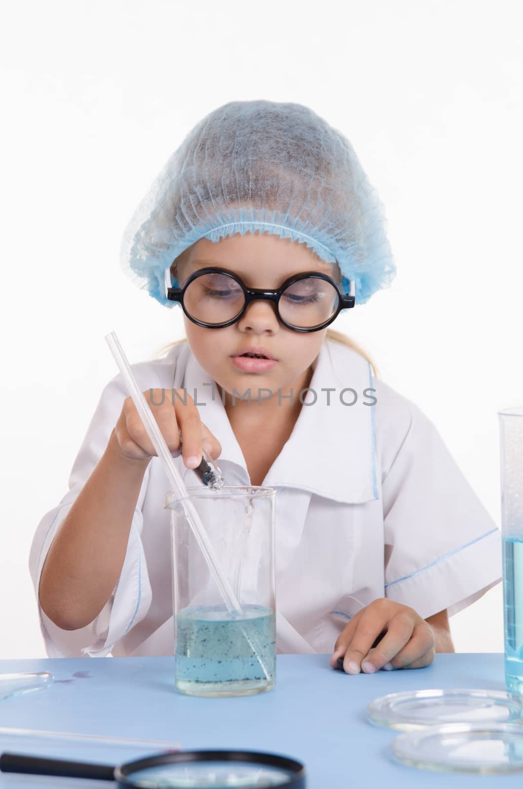 Girl sitting in chemistry class and makes the simplest experiments