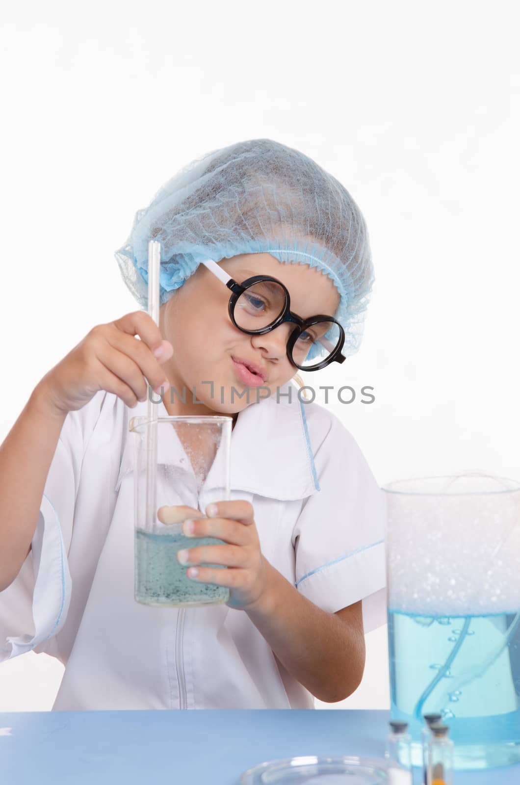 Girl sitting in chemistry class and makes the simplest experiments
