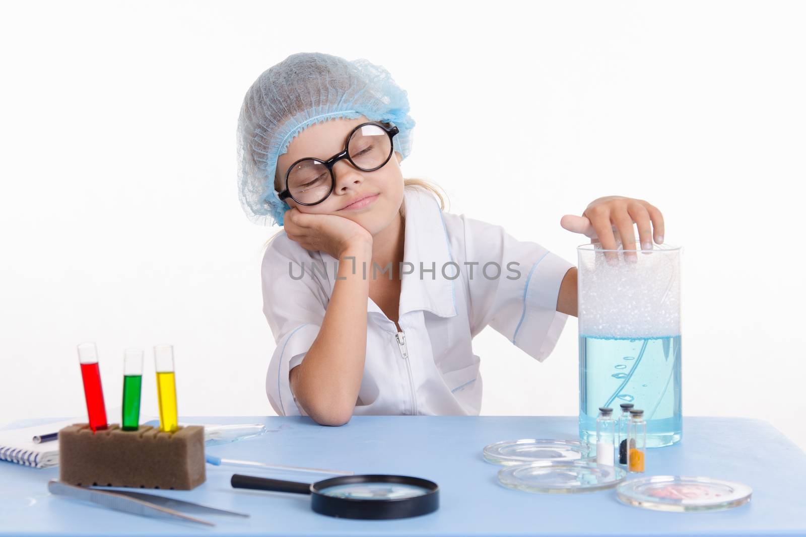 Girl sitting in chemistry class and makes the simplest experiments
