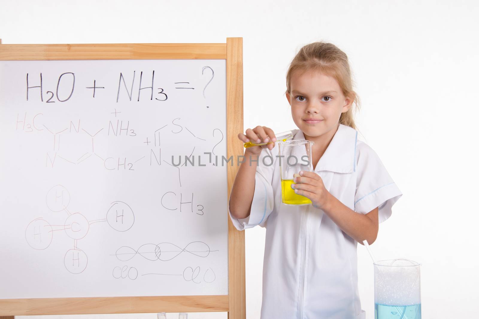 Five-year girl chemist standing at an easel in a bathrobe