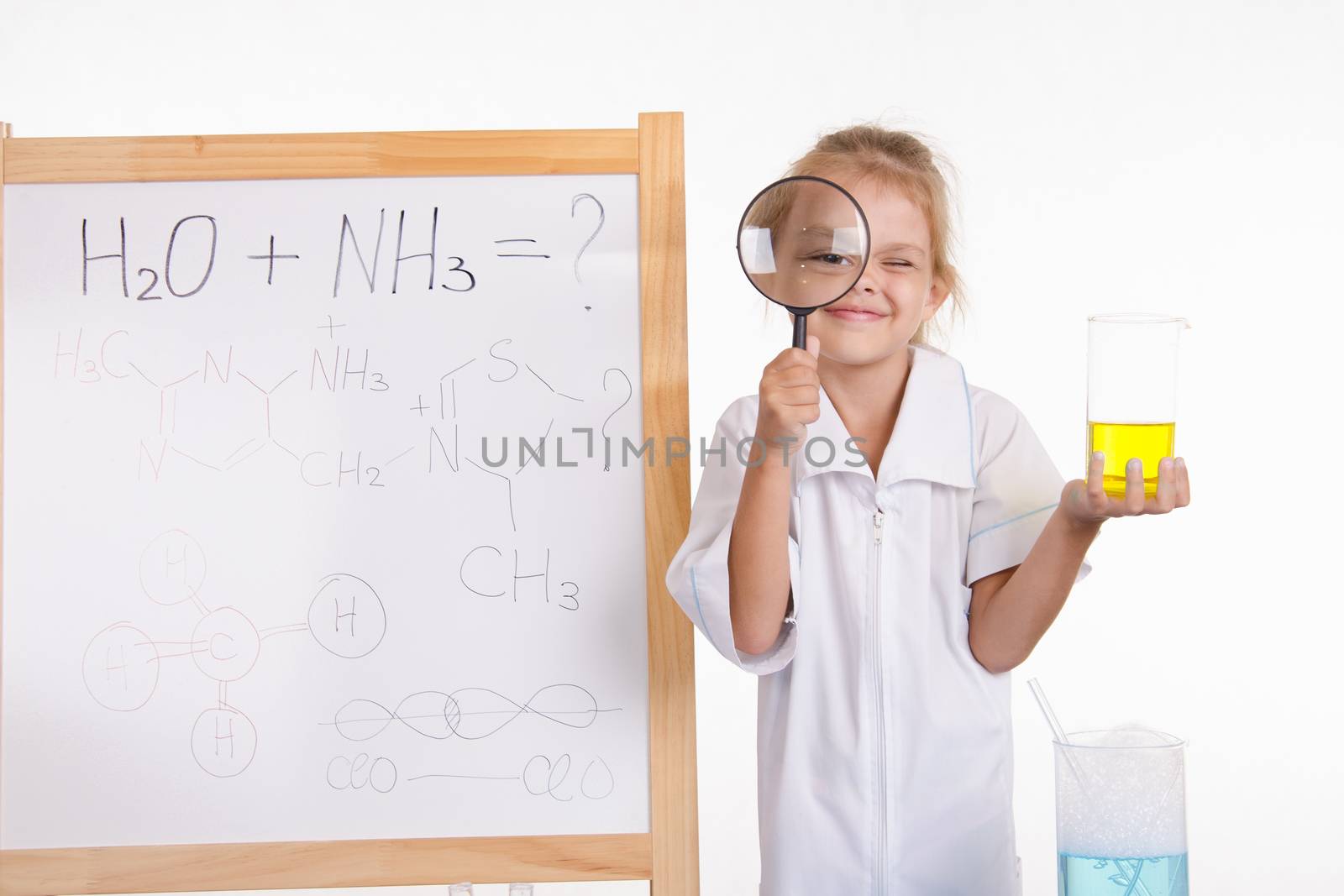 Five-year girl chemist standing at an easel in a bathrobe