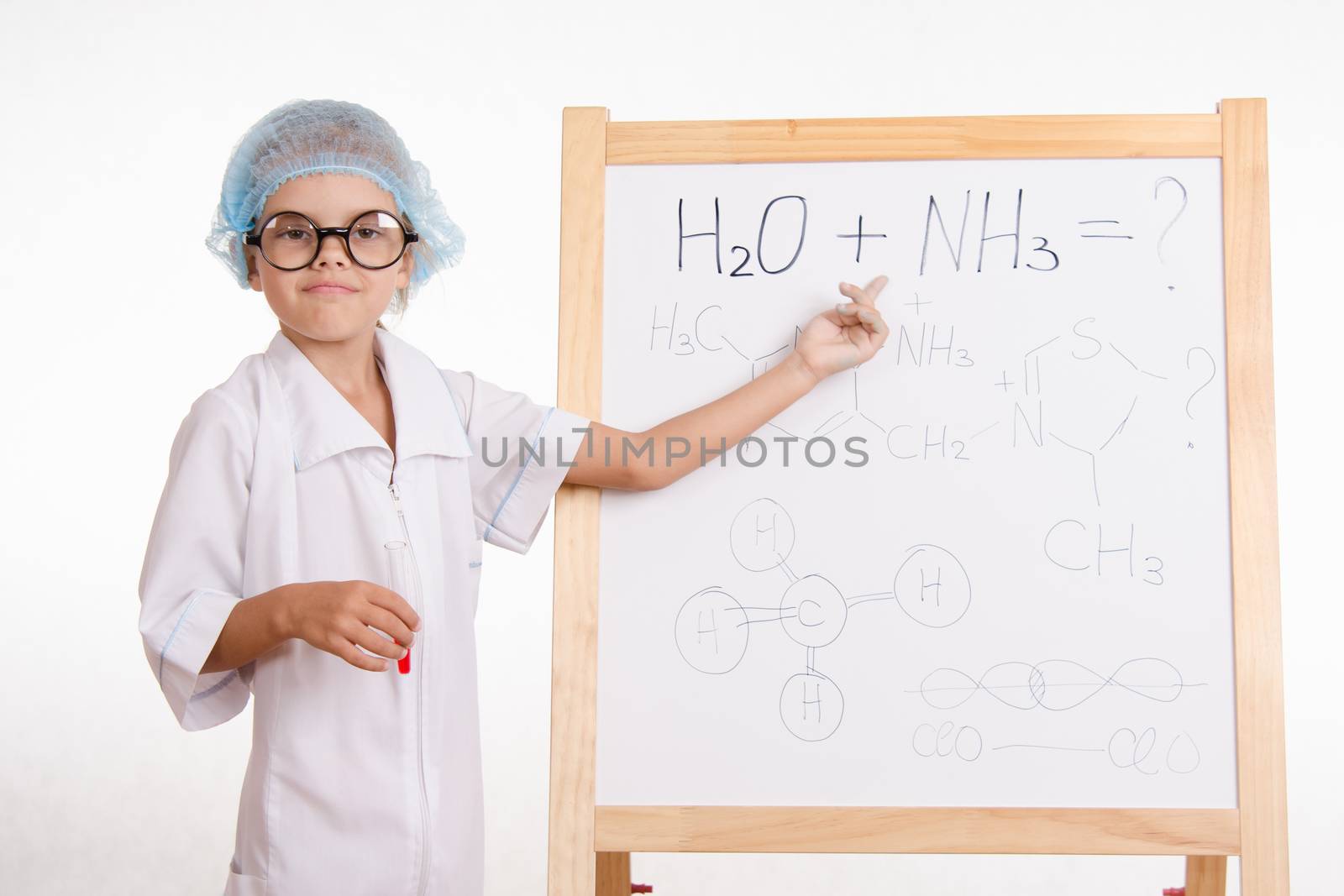 Five-year girl chemist standing at an easel in a bathrobe