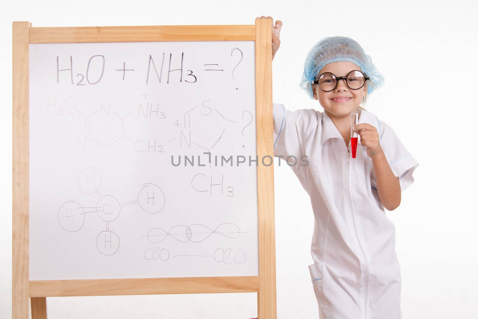 Five-year girl chemist standing at an easel in a bathrobe
