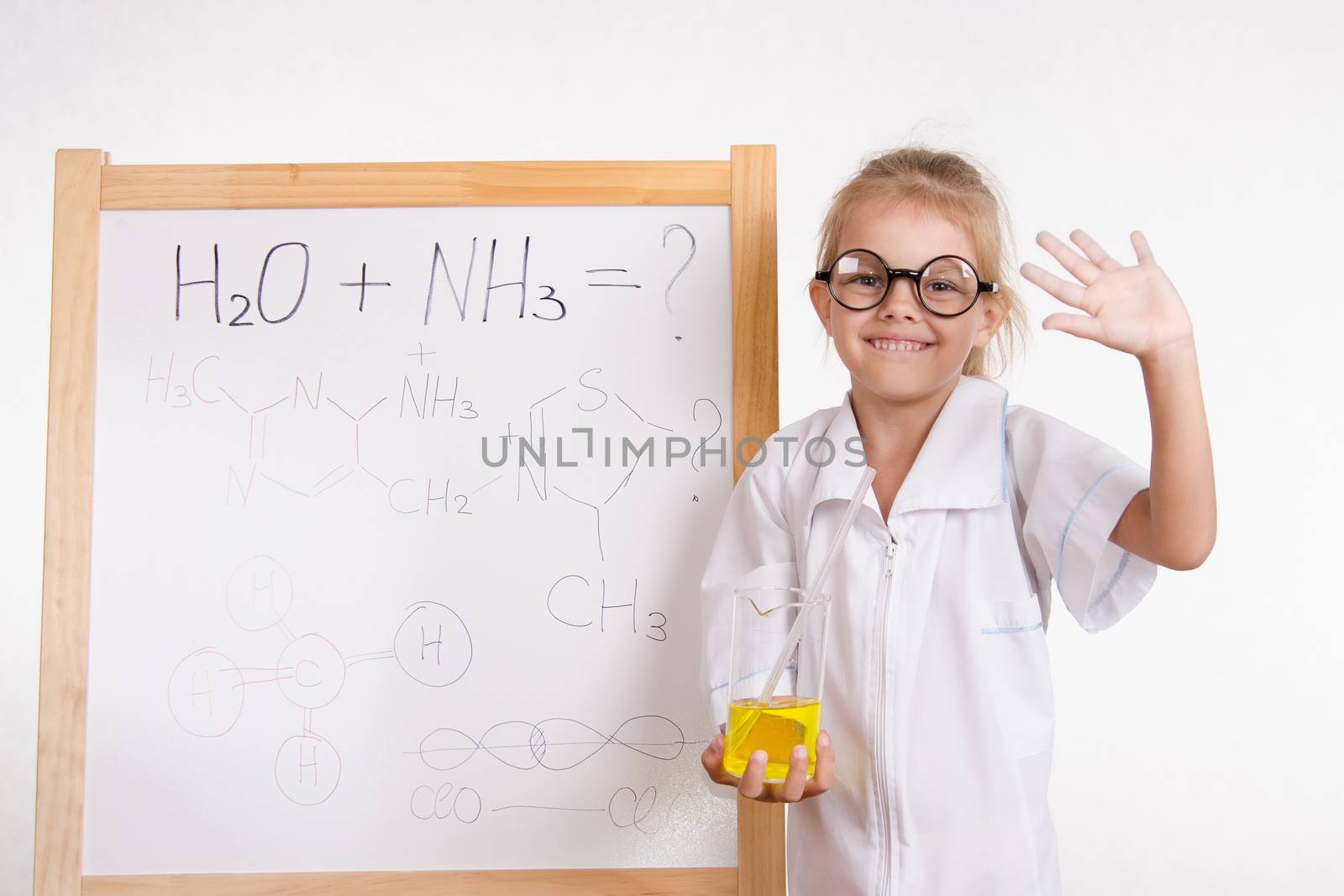 Five-year girl chemist standing at an easel in a bathrobe