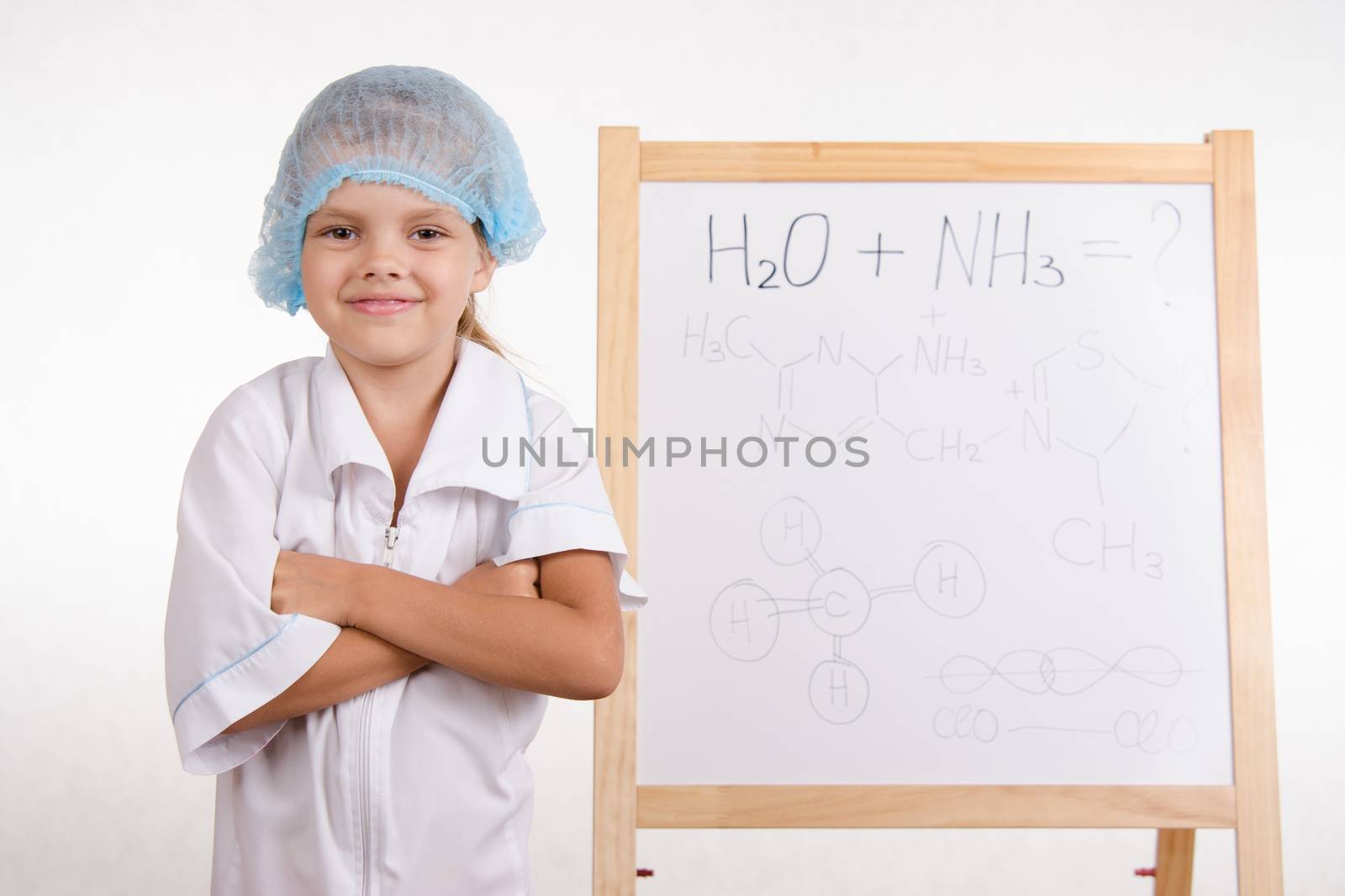 Five-year girl chemist standing at an easel in a bathrobe