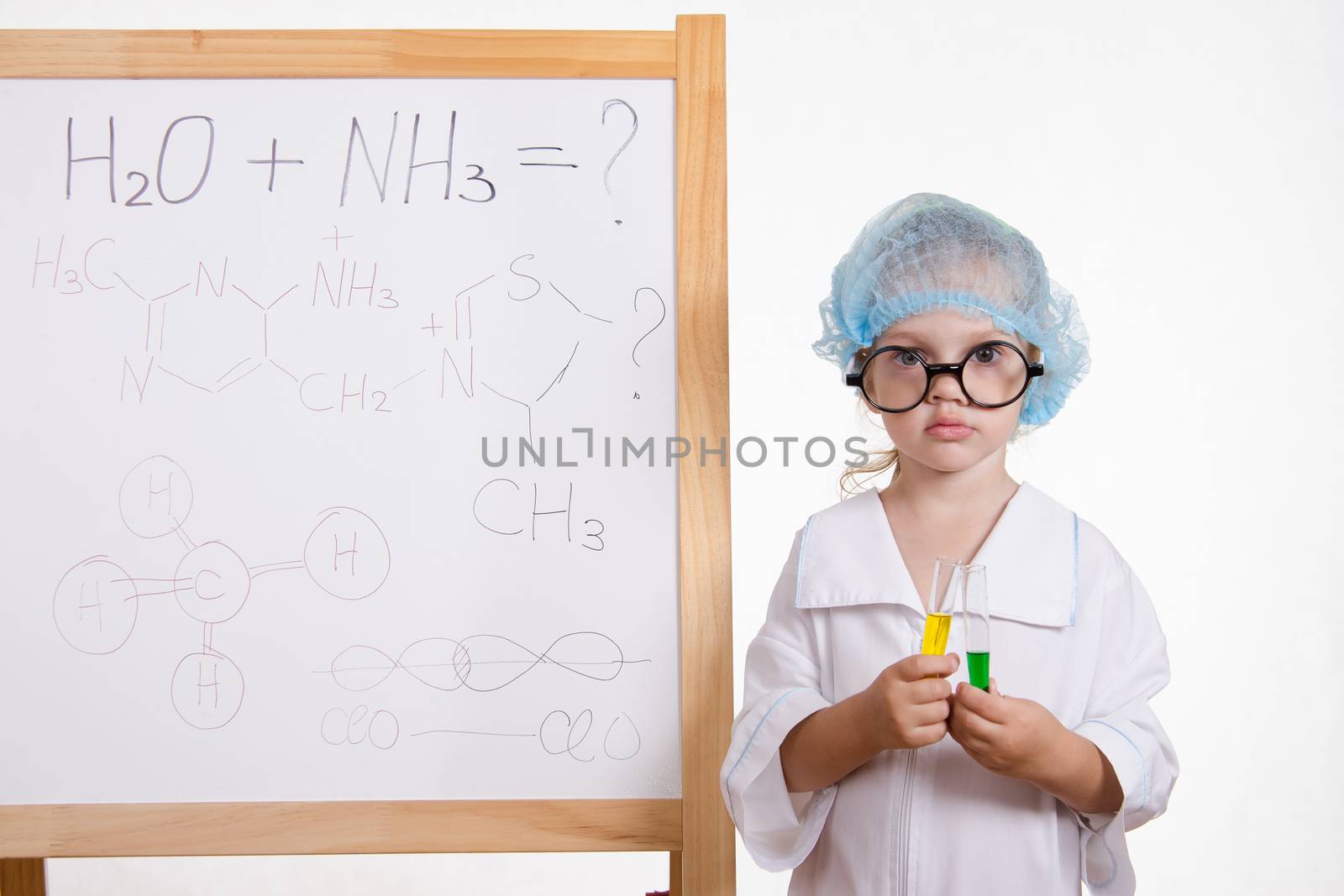 Three year old girl chemist standing at blackboard robe
