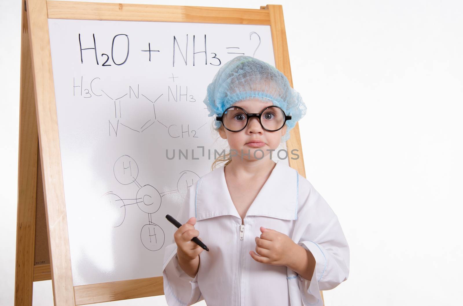 Three year old girl chemist standing at blackboard robe
