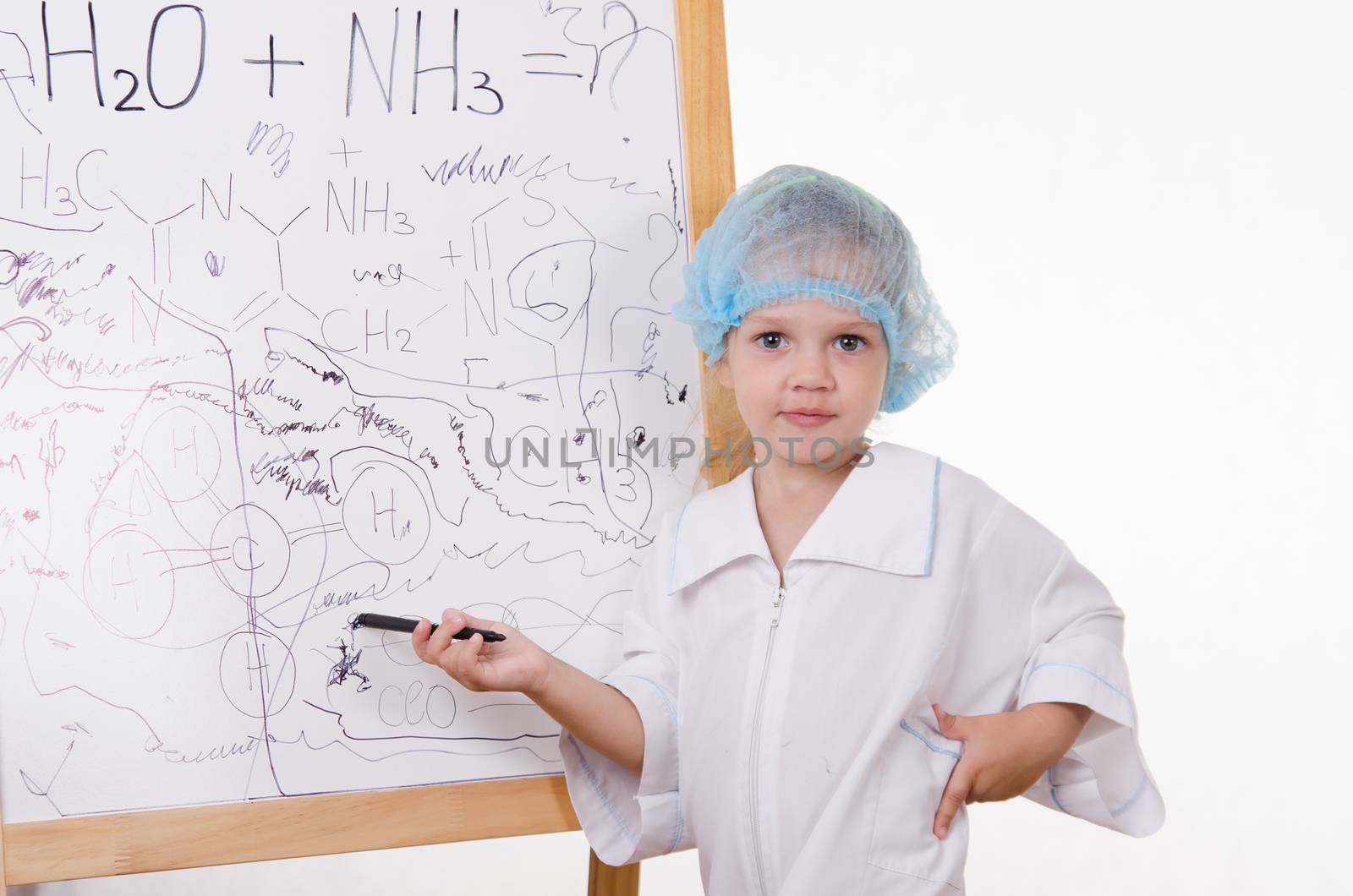 Three year old girl chemist standing at blackboard robe