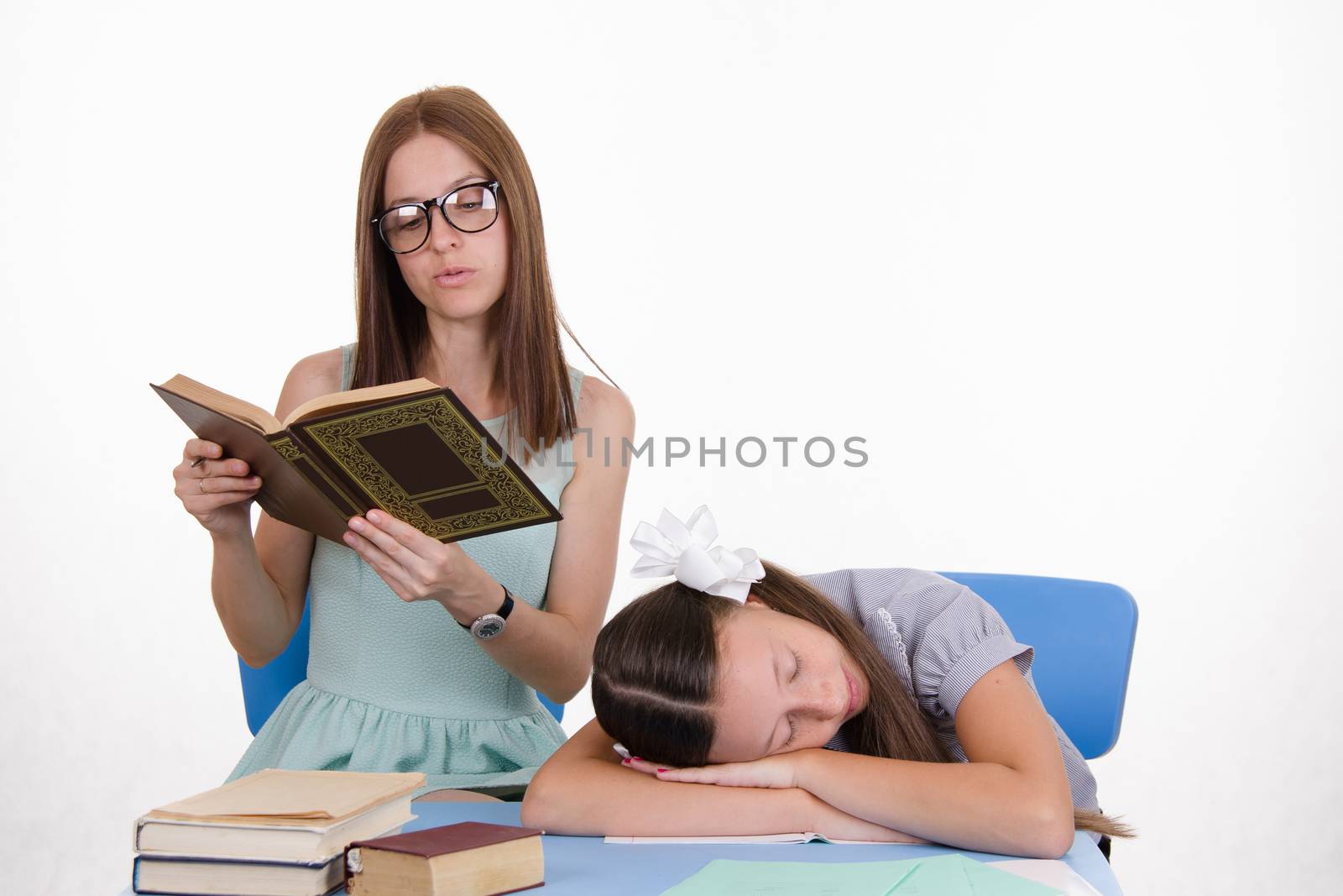 The teacher teaches student who fell asleep from boredom