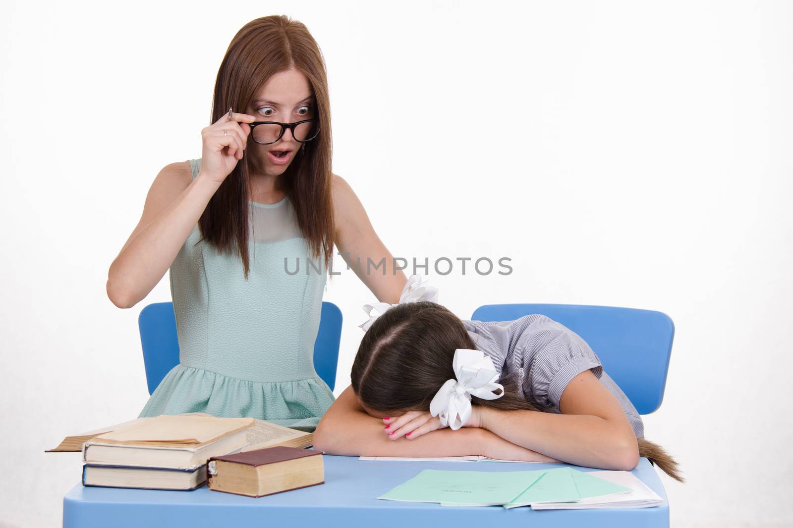 The teacher teaches student who fell asleep from boredom