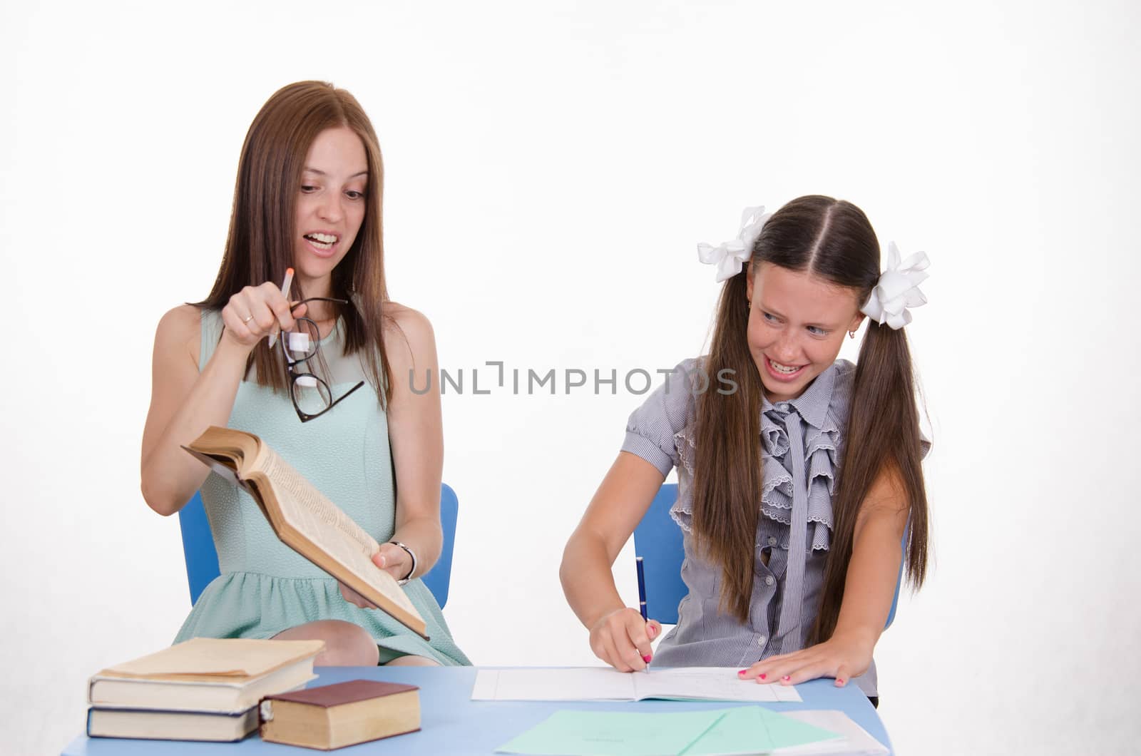 The teacher is angry with the student sitting with him at the table