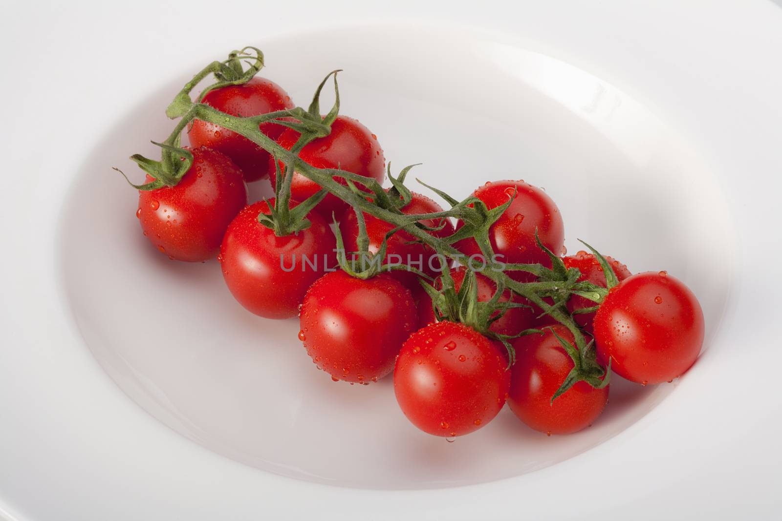 closeup of cherry tomatoes on a white plate