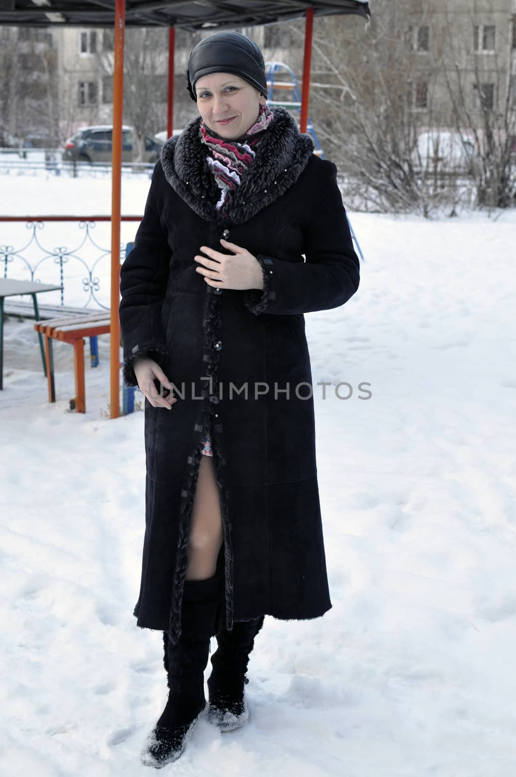 Portrait of the young beautiful woman in the winter on the street