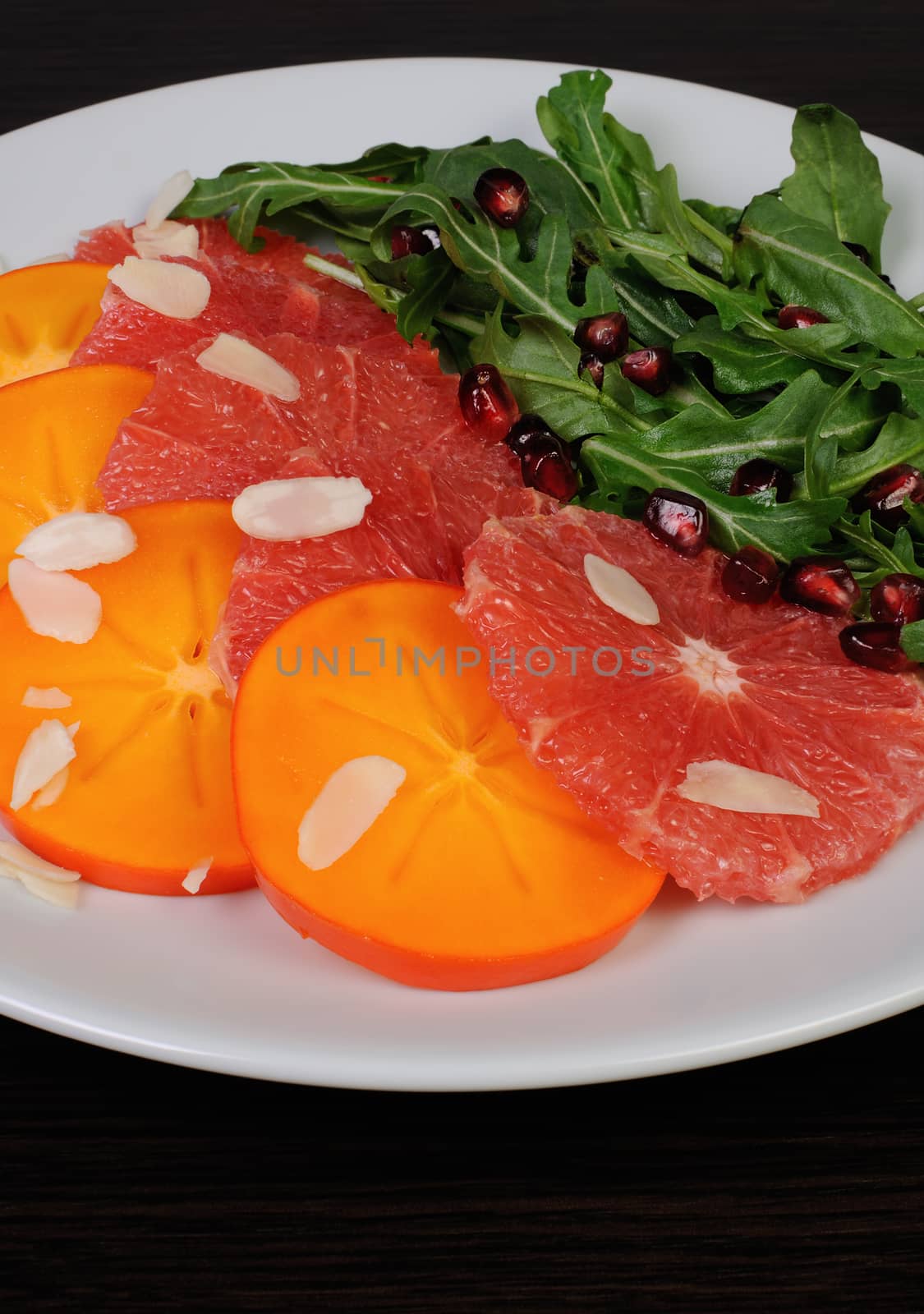 Salad of grapefruit, persimmon, pomegranate and rocket salad by Apolonia