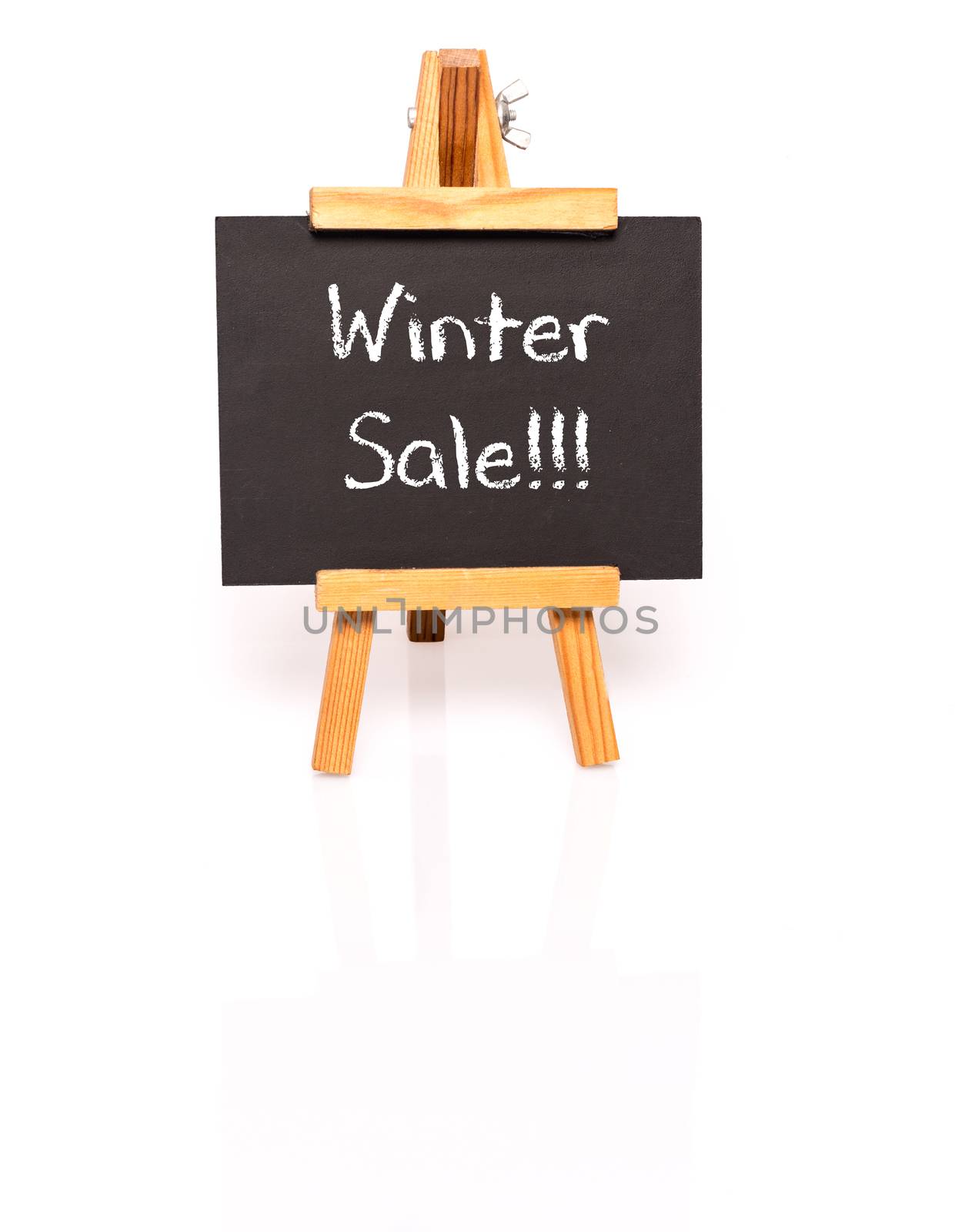 Winter Sale. Blackboard with text and easel. Photo on white background with shadow and reflection.