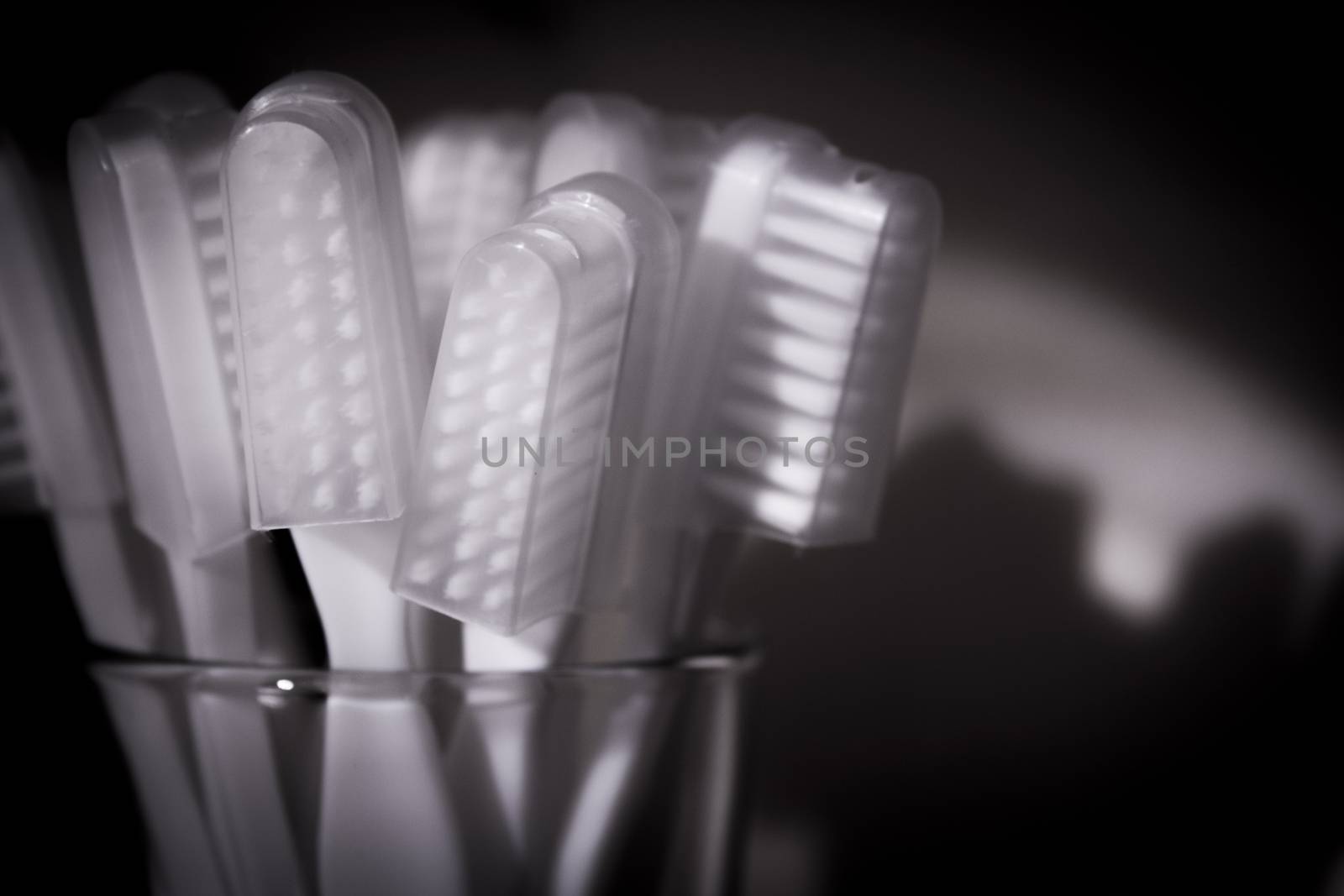 Toothbrushes in a glass. Black background.