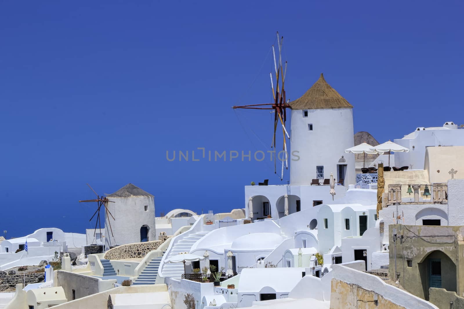 Old windmill in Oia by beautiful day, Santorini, Greece