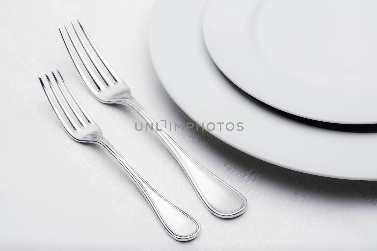 elegant table setting with silverware on white cloth