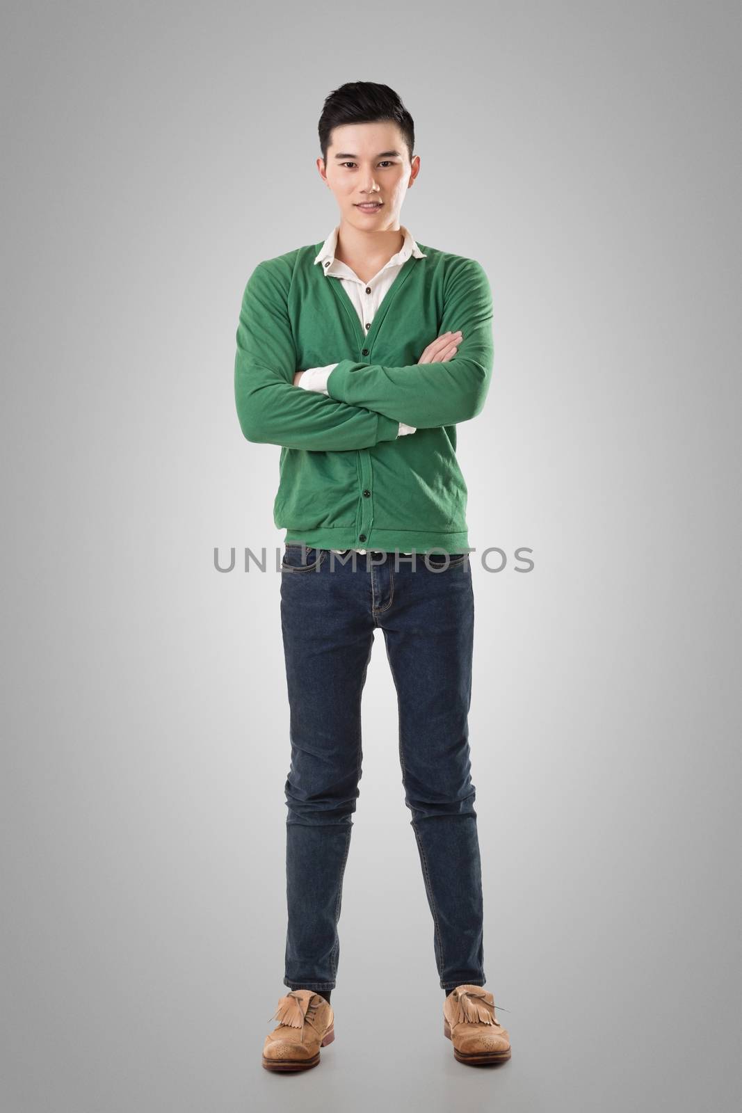 Attractive young Asian man, full length portrait isolated on white background.