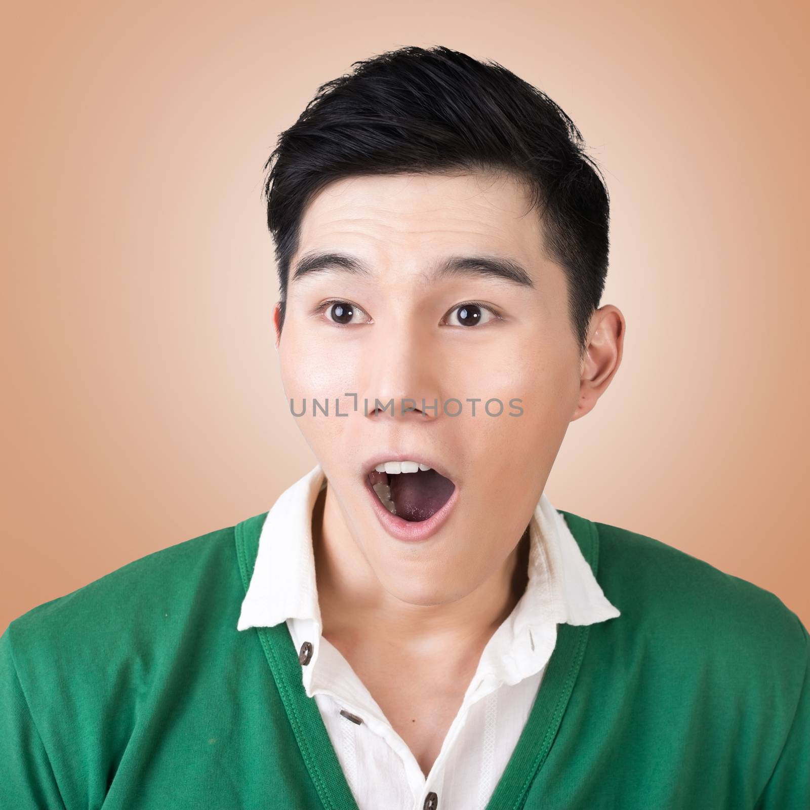 Funny facial expression, closeup Asian young man.