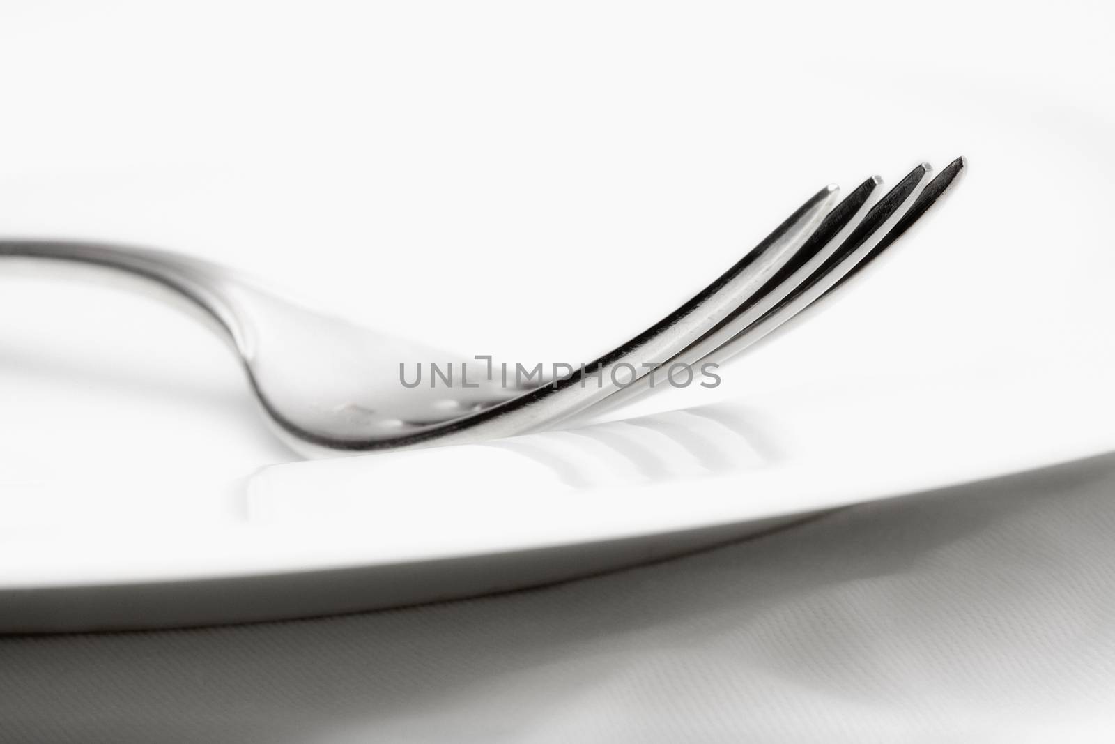 silverware - closeup of a fork by courtyardpix