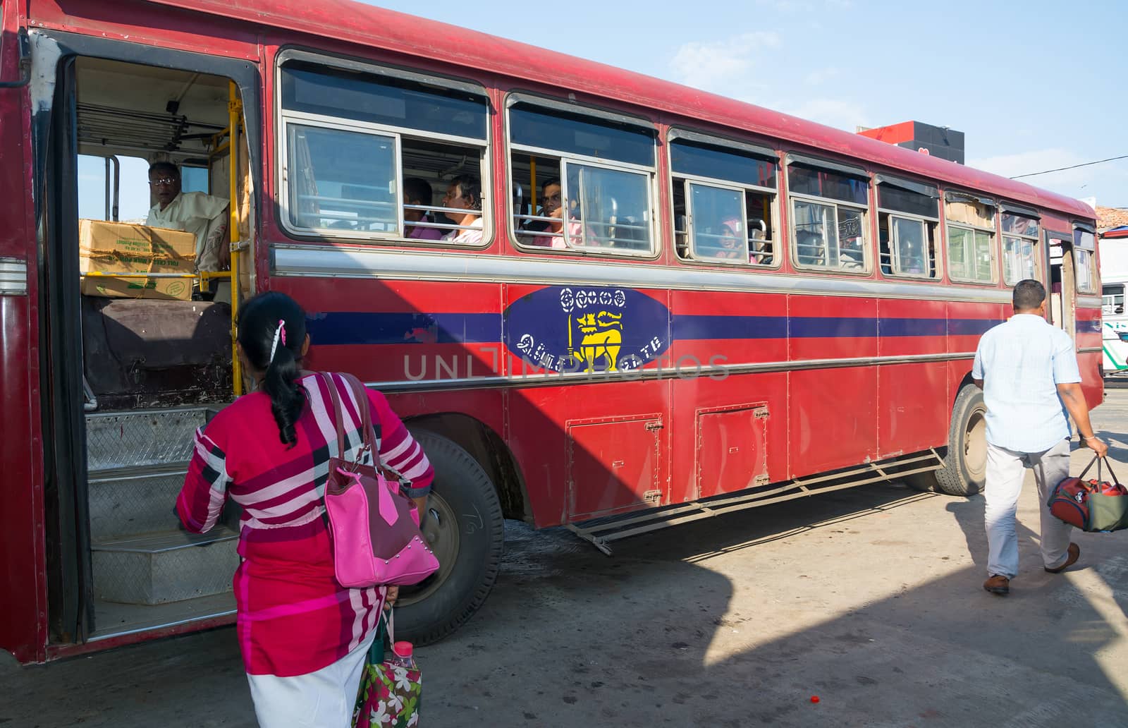 TANGALLE, SOUTHERN PROVINCE, SRI LANKA - DECEMBER 15, 2014: Red bus in Tangalle on December 15 2014 in Tangalle, Southern Province, Sri Lanka, Asia.