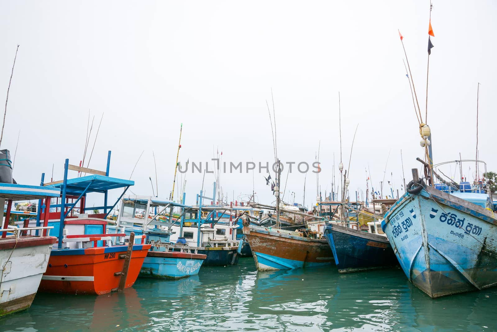 TANGALLE, SOUTHERN PROVINCE, SRI LANKA, ASIA - DECEMBER 20, 2014: Colorful wood fishing boats moored on December 20, 2014 in Tangalle port, Southern Province, Sri Lanka.