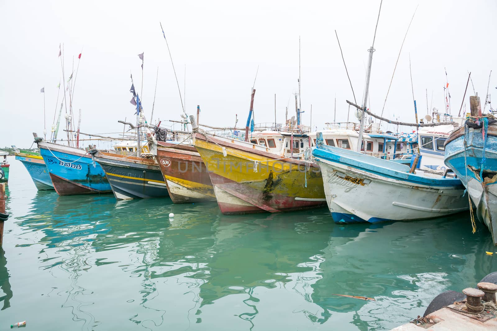 TANGALLE, SOUTHERN PROVINCE, SRI LANKA, ASIA - DECEMBER 20, 2014: Colorful wood fishing boats moored on December 20, 2014 in Tangalle port, Southern Province, Sri Lanka.