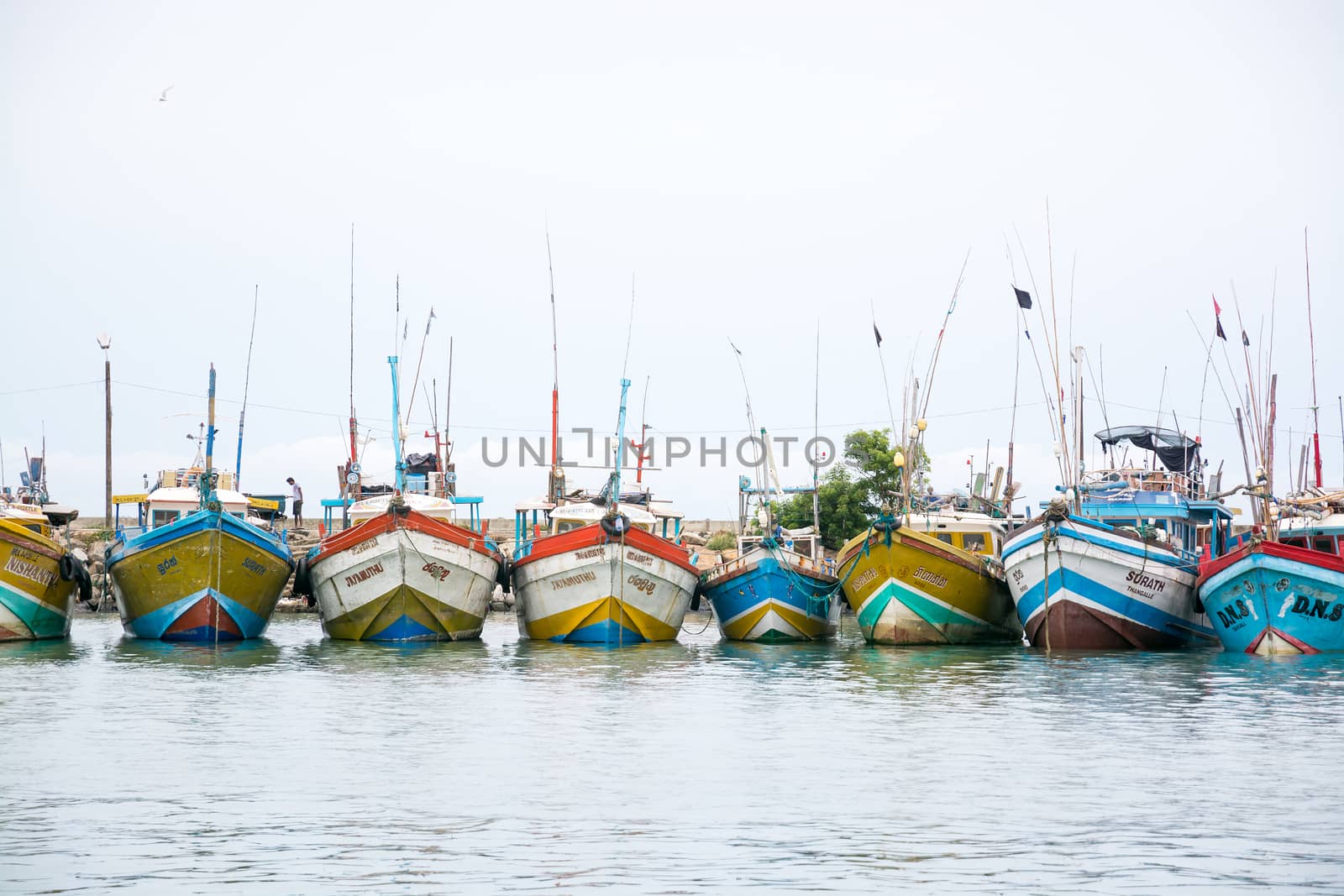 TANGALLE, SOUTHERN PROVINCE, SRI LANKA, ASIA - DECEMBER 20, 2014: Colorful wood fishing boats moored on December 20, 2014 in Tangalle port, Southern Province, Sri Lanka.