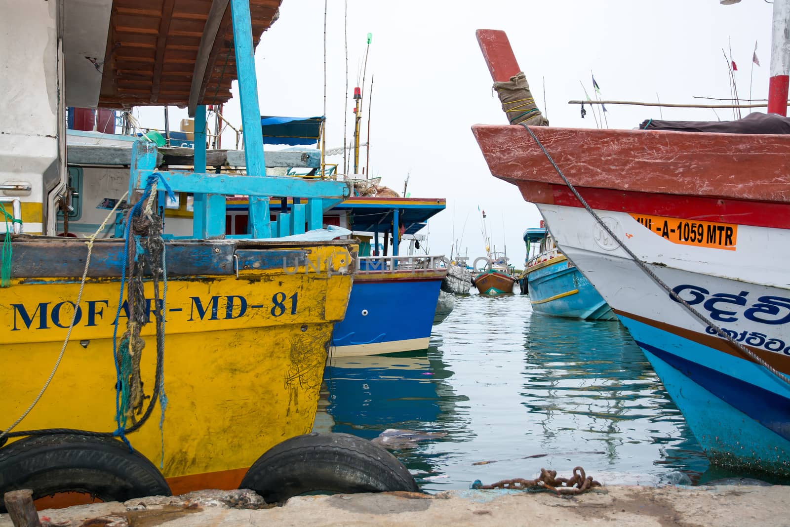 TANGALLE, SOUTHERN PROVINCE, SRI LANKA, ASIA - DECEMBER 20, 2014: Colorful wood fishing boats moored on December 20, 2014 in Tangalle port, Southern Province, Sri Lanka.