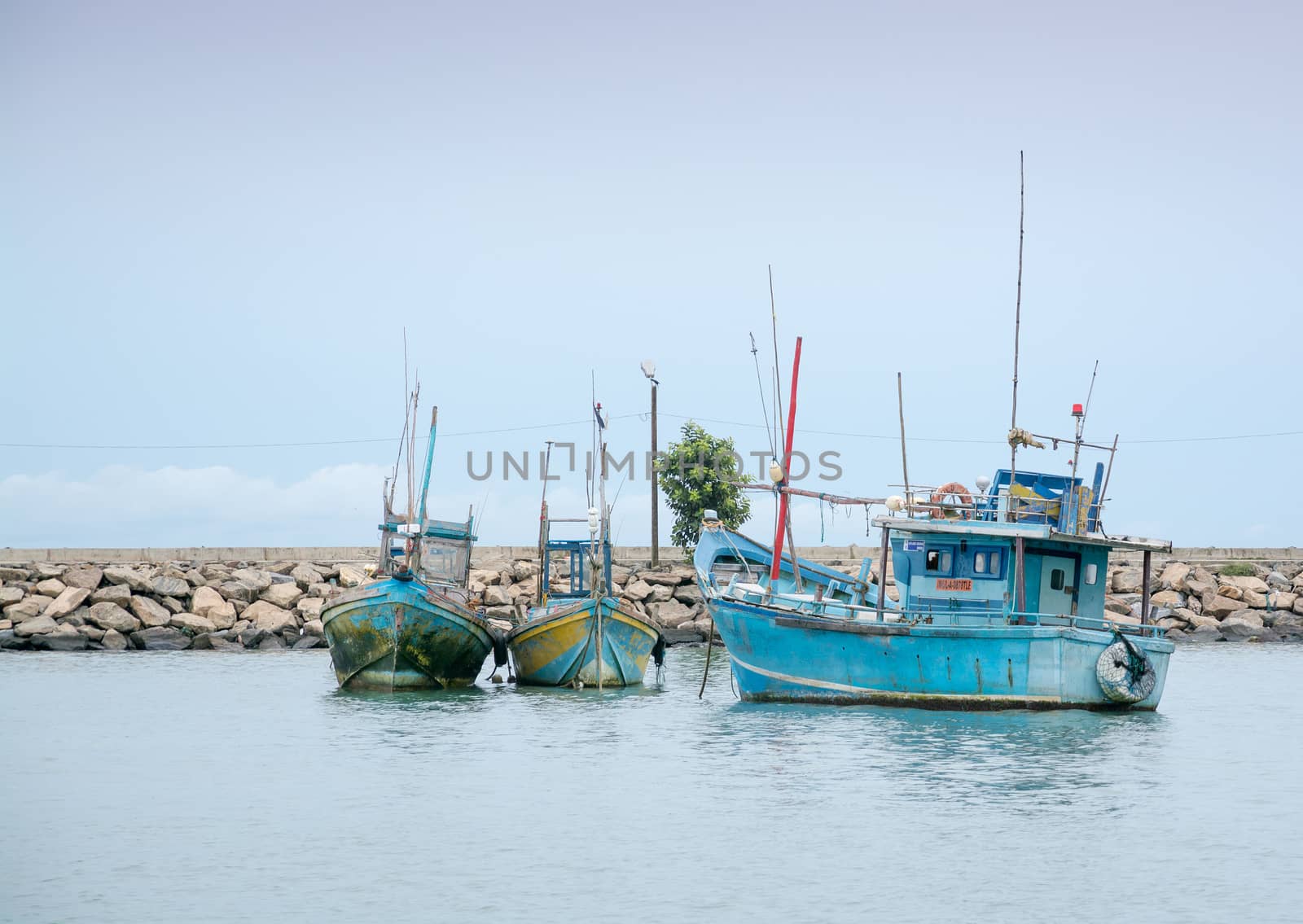 TANGALLE, SOUTHERN PROVINCE, SRI LANKA, ASIA - DECEMBER 20, 2014: Colorful wood fishing boats moored on December 20, 2014 in Tangalle port, Southern Province, Sri Lanka.