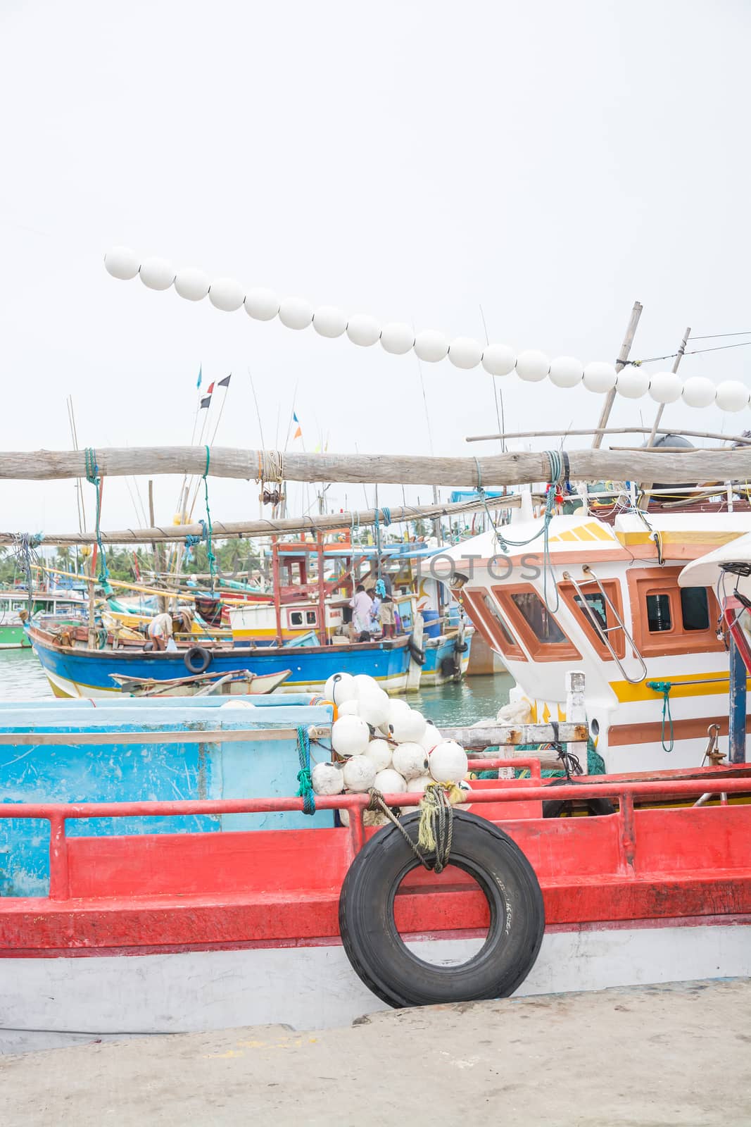 TANGALLE, SOUTHERN PROVINCE, SRI LANKA, ASIA - DECEMBER 20, 2014: Colorful wood fishing boats moored on December 20, 2014 in Tangalle port, Southern Province, Sri Lanka.