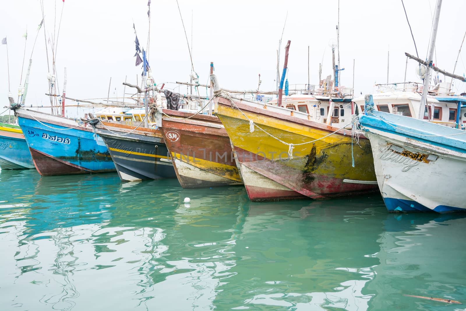 TANGALLE, SOUTHERN PROVINCE, SRI LANKA, ASIA - DECEMBER 20, 2014: Colorful wood fishing boats moored on December 20, 2014 in Tangalle port, Southern Province, Sri Lanka.