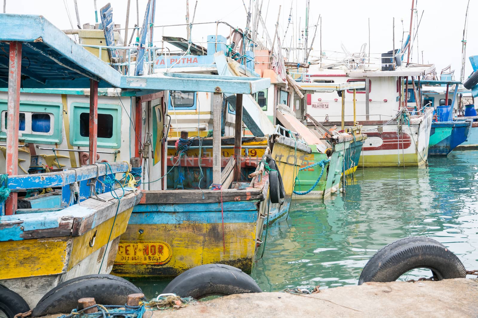 TANGALLE, SOUTHERN PROVINCE, SRI LANKA, ASIA - DECEMBER 20, 2014: Colorful wood fishing boats moored on December 20, 2014 in Tangalle port, Southern Province, Sri Lanka.