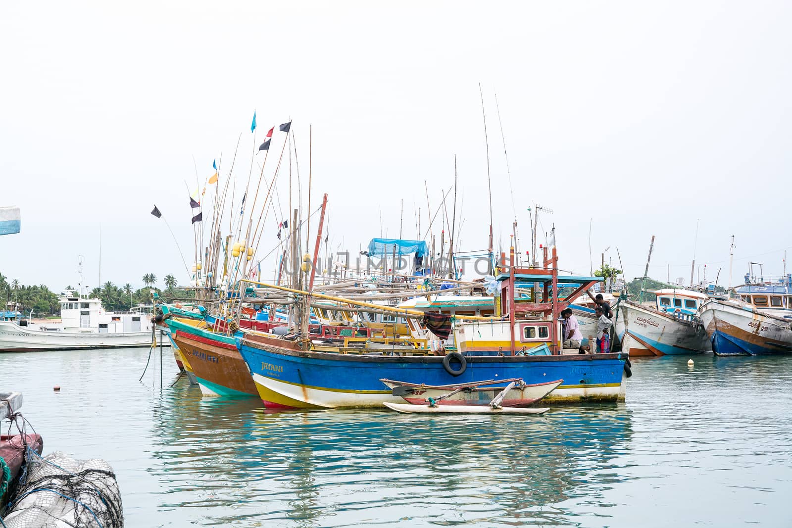 TANGALLE, SOUTHERN PROVINCE, SRI LANKA, ASIA - DECEMBER 20, 2014: Colorful wood fishing boats moored on December 20, 2014 in Tangalle port, Southern Province, Sri Lanka.