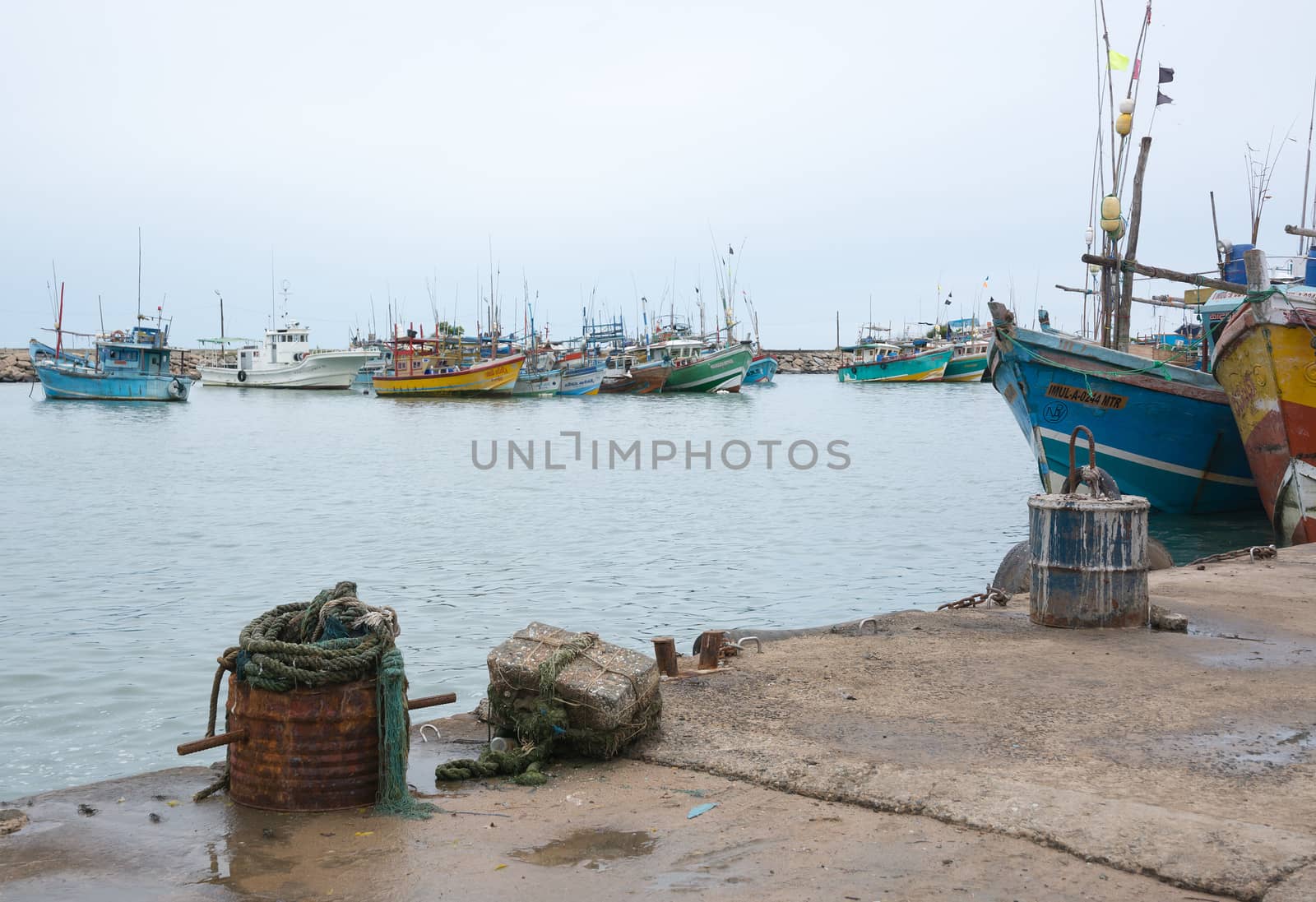 TANGALLE, SOUTHERN PROVINCE, SRI LANKA, ASIA - DECEMBER 20, 2014: Colorful wood fishing boats moored on December 20, 2014 in Tangalle port, Southern Province, Sri Lanka.