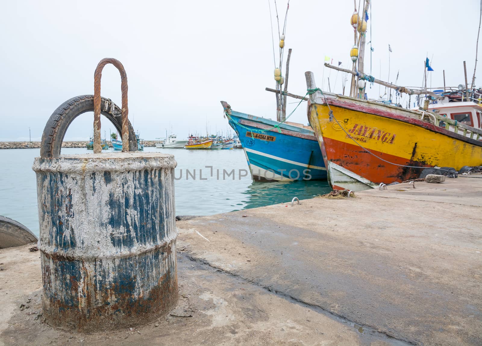 TANGALLE, SOUTHERN PROVINCE, SRI LANKA, ASIA - DECEMBER 20, 2014: Colorful wood fishing boats moored on December 20, 2014 in Tangalle port, Southern Province, Sri Lanka.