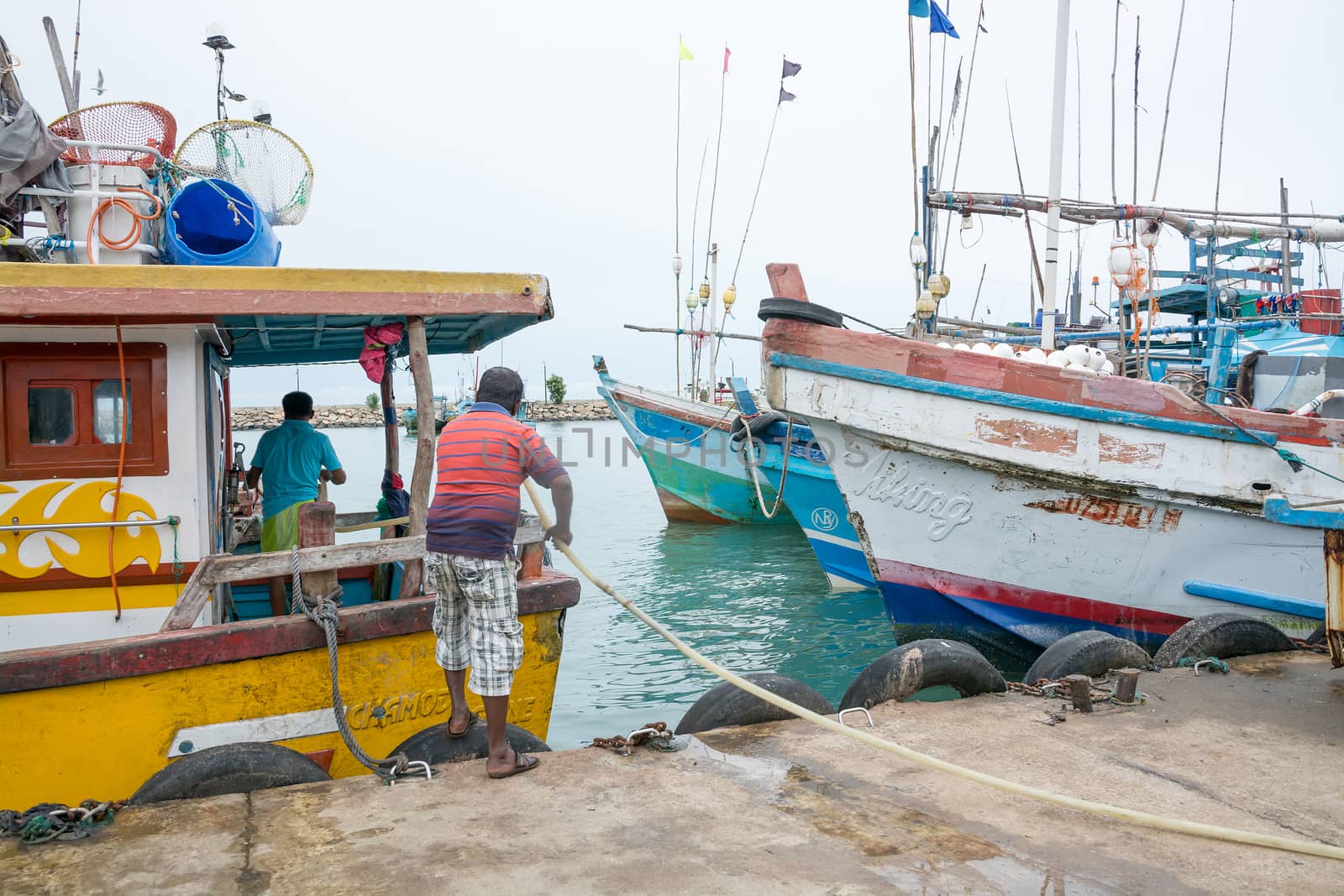 TANGALLE, SOUTHERN PROVINCE, SRI LANKA, ASIA - DECEMBER 20, 2014: Colorful wood fishing boats moored on December 20, 2014 in Tangalle port, Southern Province, Sri Lanka.