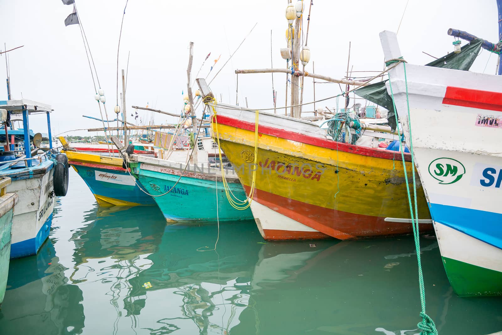 TANGALLE, SOUTHERN PROVINCE, SRI LANKA, ASIA - DECEMBER 20, 2014: Colorful wood fishing boats moored on December 20, 2014 in Tangalle port, Southern Province, Sri Lanka.