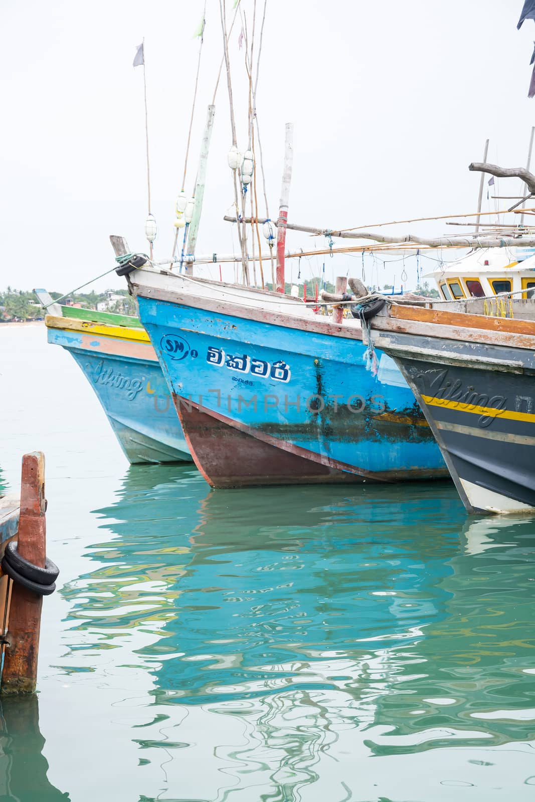 TANGALLE, SOUTHERN PROVINCE, SRI LANKA, ASIA - DECEMBER 20, 2014: Colorful wood fishing boats moored on December 20, 2014 in Tangalle port, Southern Province, Sri Lanka.