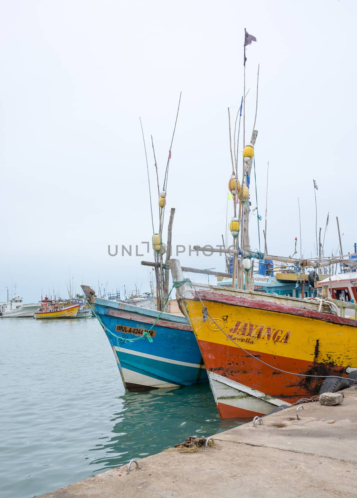 TANGALLE, SOUTHERN PROVINCE, SRI LANKA, ASIA - DECEMBER 20, 2014: Colorful wood fishing boats moored on December 20, 2014 in Tangalle port, Southern Province, Sri Lanka.