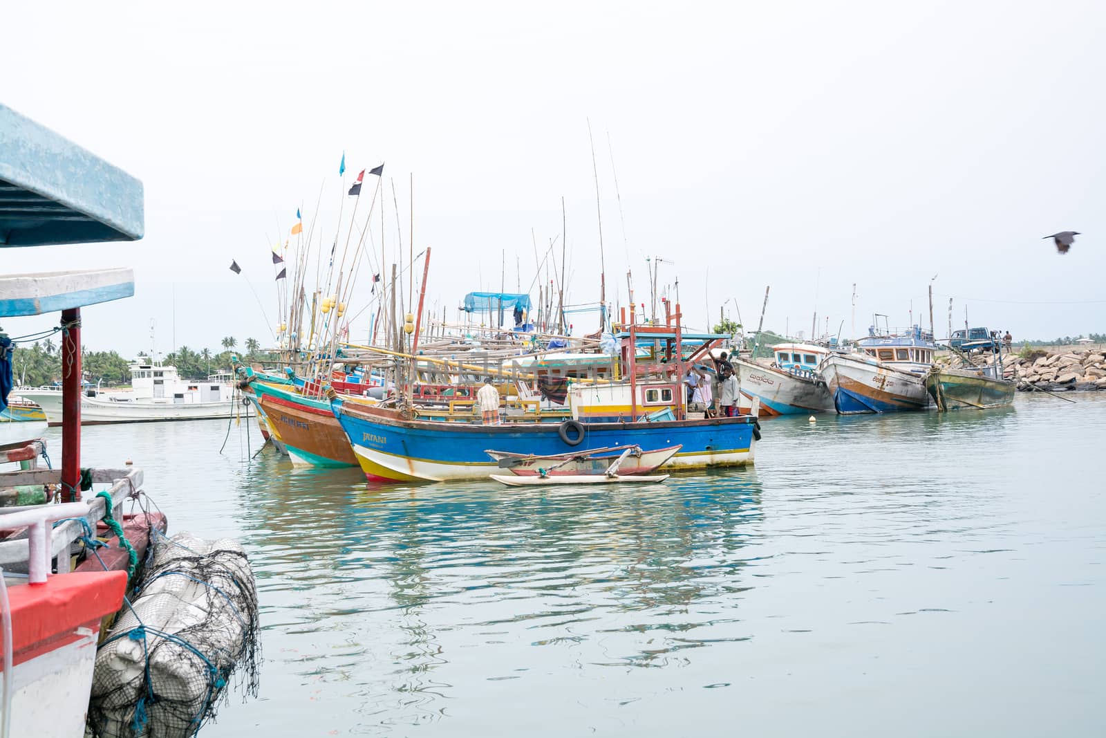 TANGALLE, SOUTHERN PROVINCE, SRI LANKA, ASIA - DECEMBER 20, 2014: Colorful wood fishing boats moored on December 20, 2014 in Tangalle port, Southern Province, Sri Lanka.