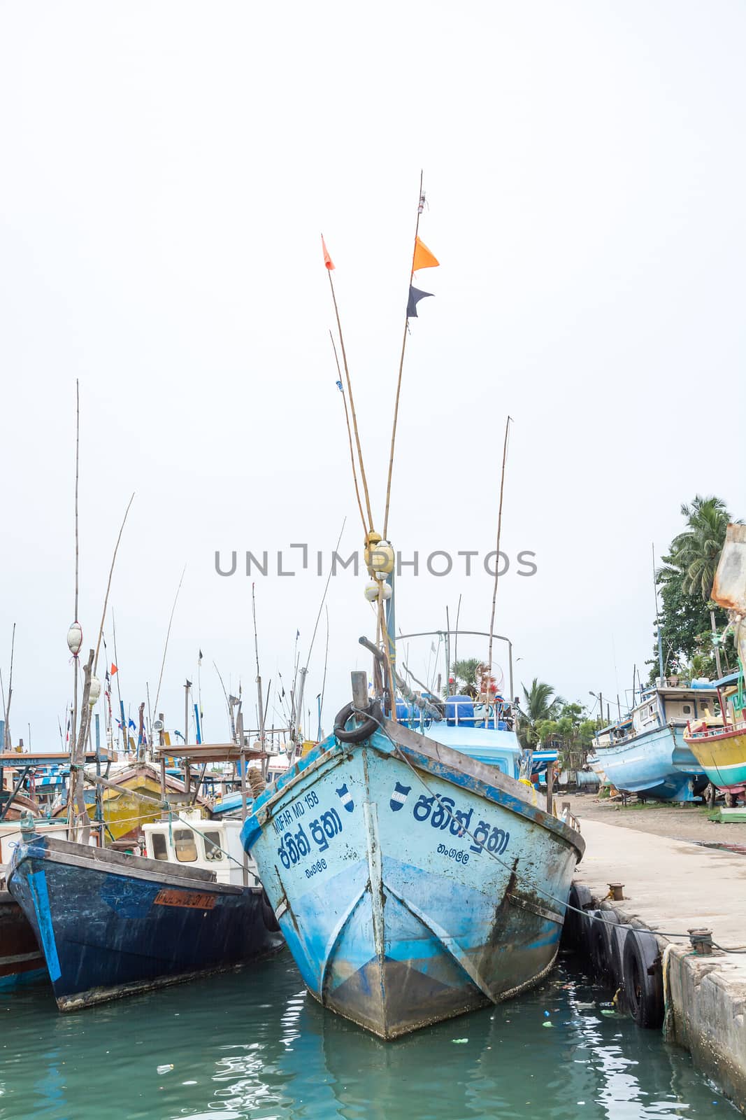 TANGALLE, SOUTHERN PROVINCE, SRI LANKA, ASIA - DECEMBER 20, 2014: Colorful wood fishing boats moored on December 20, 2014 in Tangalle port, Southern Province, Sri Lanka.