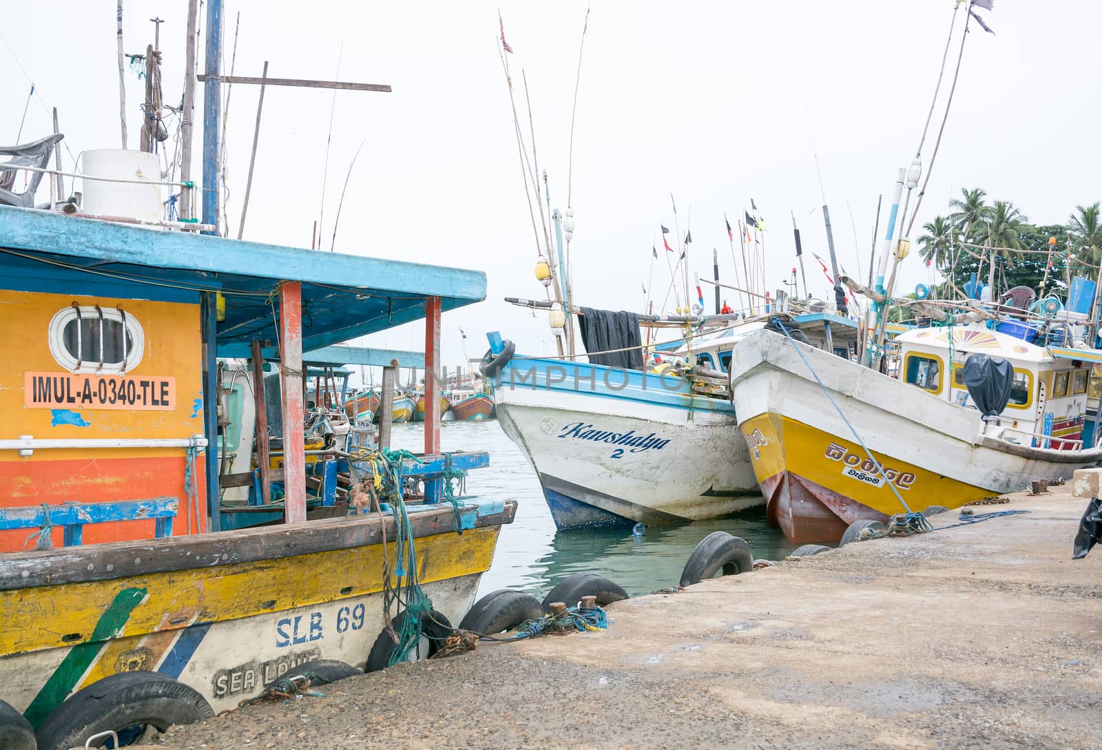 TANGALLE, SOUTHERN PROVINCE, SRI LANKA, ASIA - DECEMBER 20, 2014: Colorful wood fishing boats moored on December 20, 2014 in Tangalle port, Southern Province, Sri Lanka.