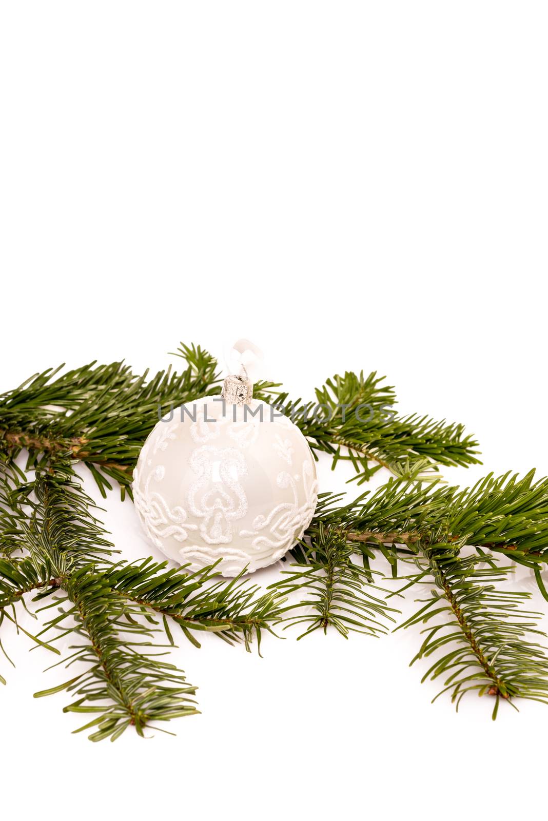 Closeup of Christmas ball and fir branch on white background with space for your text
