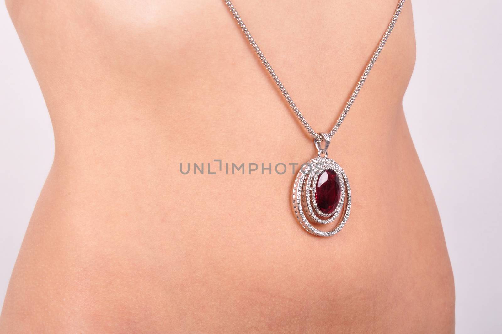pendant on a background of the body of a young woman by Nikola30